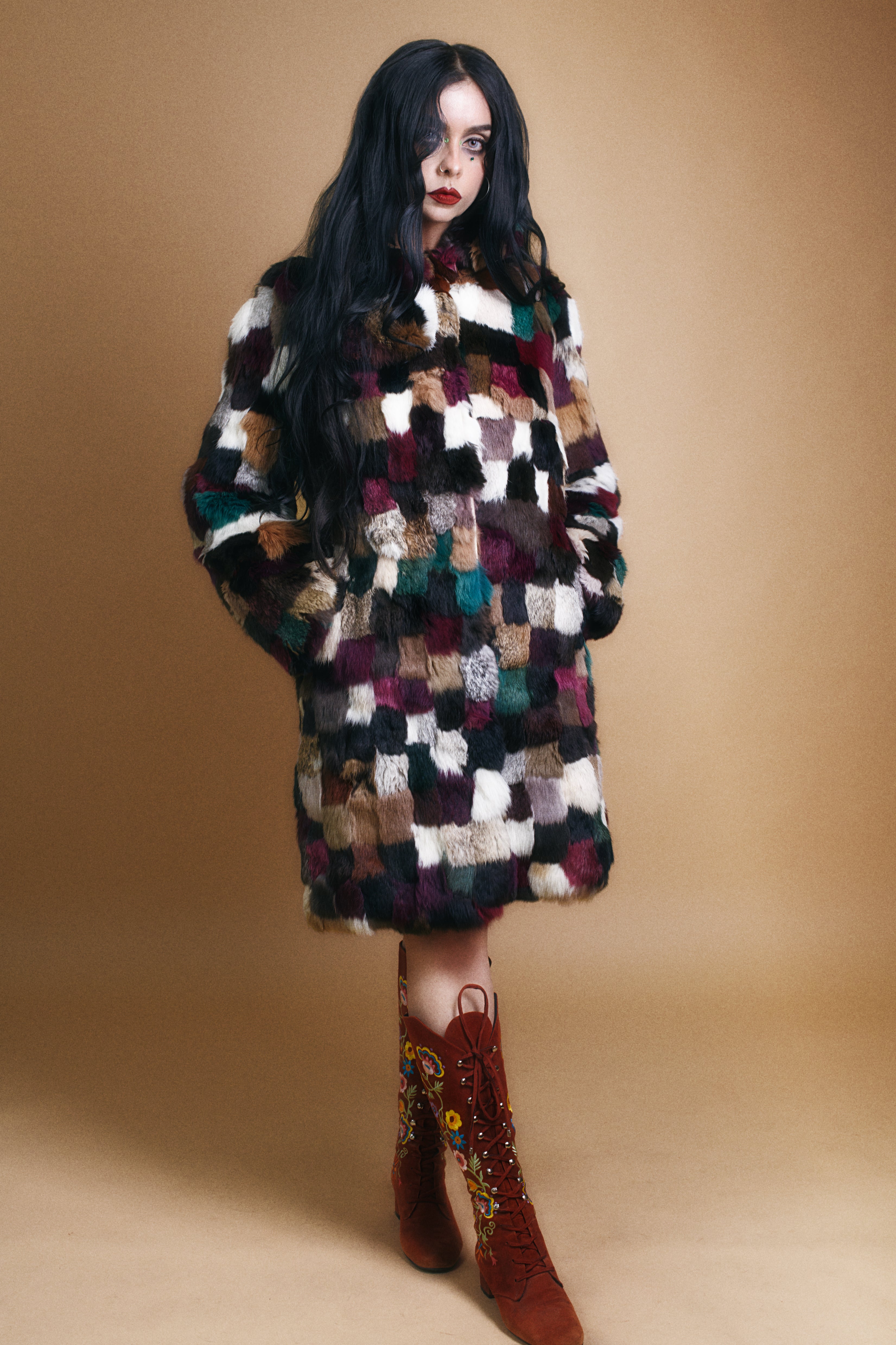 Luxury 1970s patchwork fur coat styled on model against neutral background